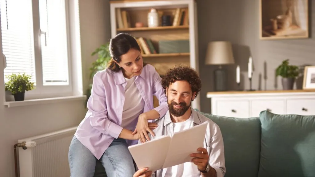 a woman and man looking at budgeting worksheets