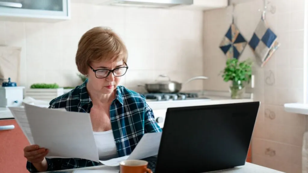 elder woman looking at papers