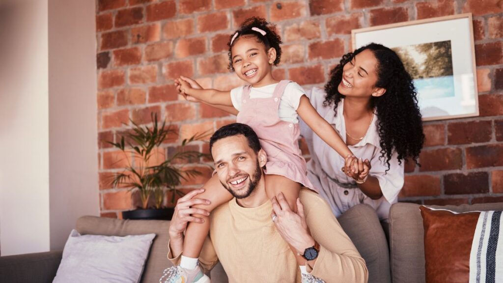 Family of three sitting on the couch